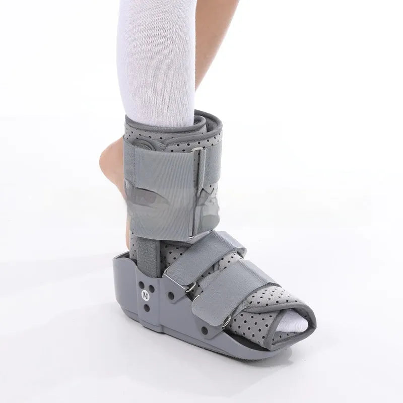 A black Achilles tendon rehabilitation boot with fixed support, showing straps and structural design.