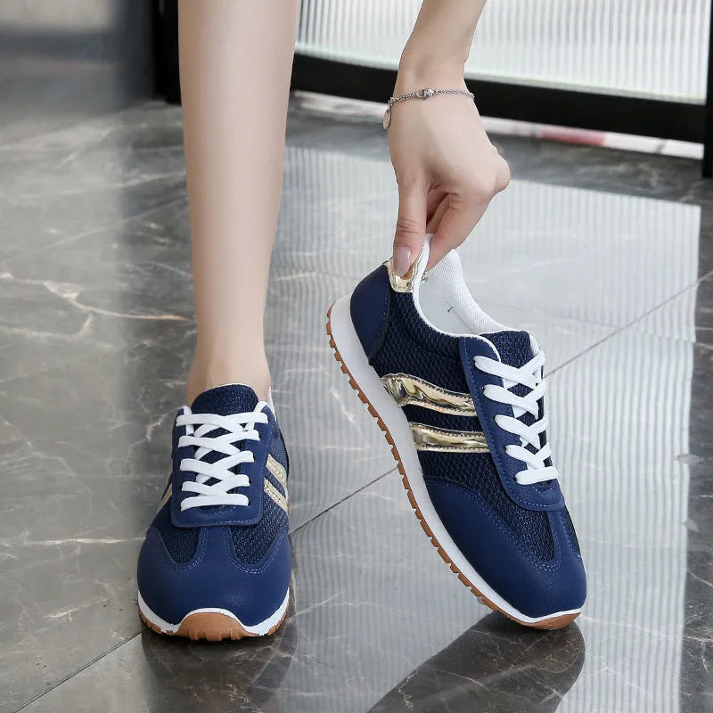 Blue women's casual sports trainers with cross shoulder straps and a white non-slip rubber sole.