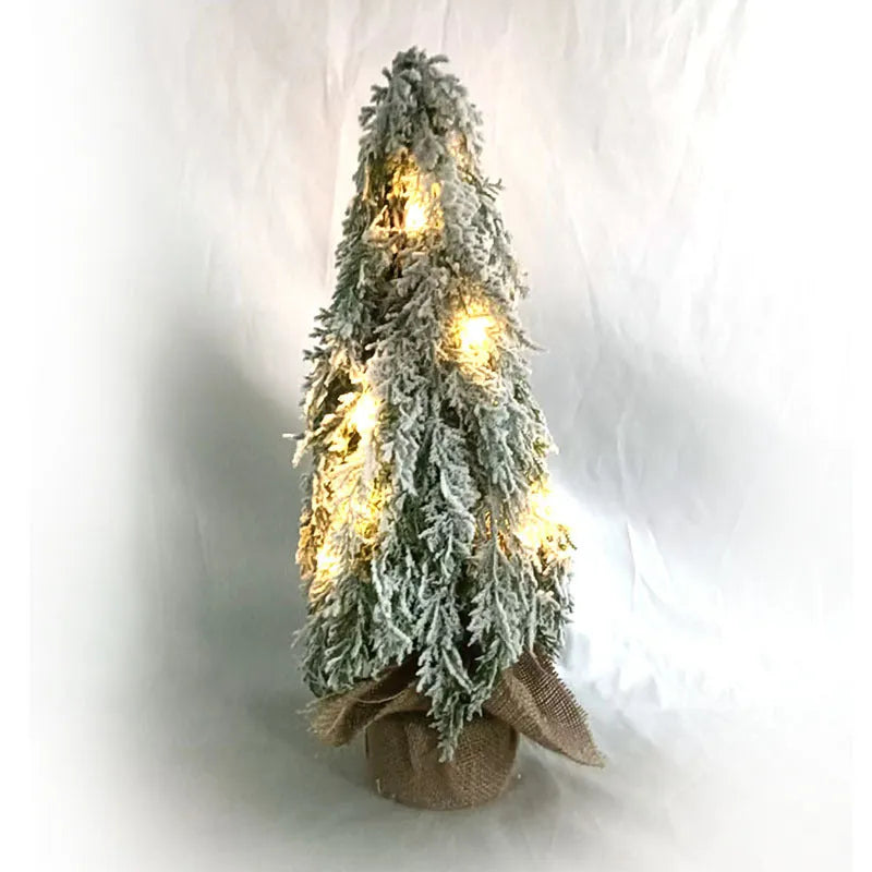Small 24-inch artificial Christmas tree with LED lights and snow sprayer ornament on desktop