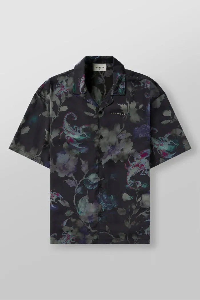 Man wearing a loose fit, short sleeve printed floral top in a neutral colour