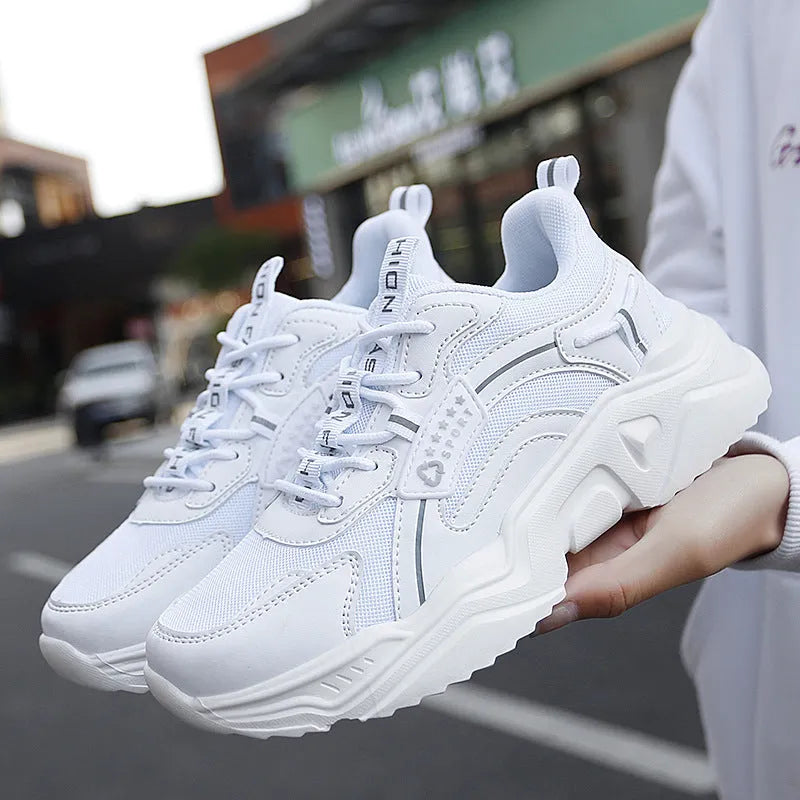 White women's casual sports shoes with mesh upper, thick PU sole, round toe, and buckle detail.