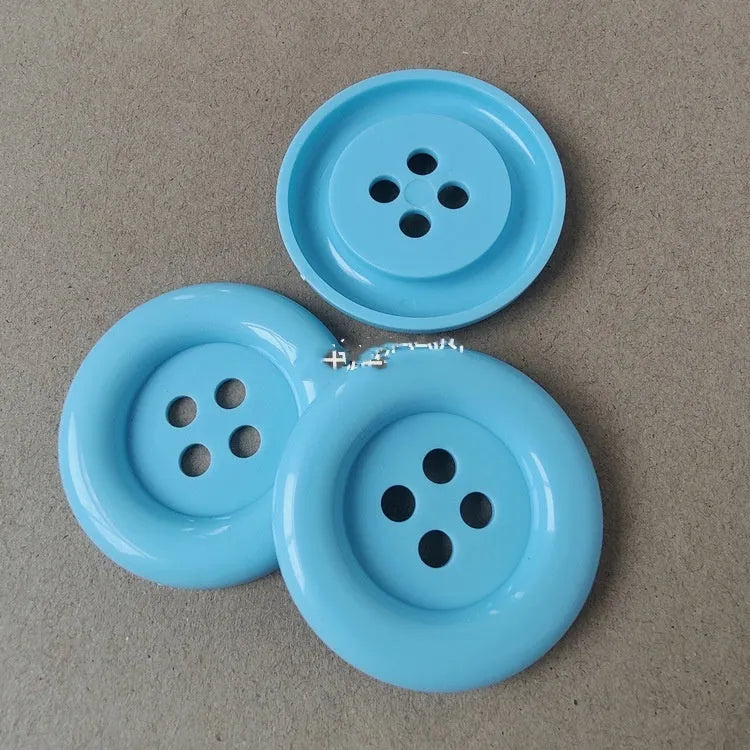 Oversized round edge plastic nylon sewing buttons with four holes in multiple colours