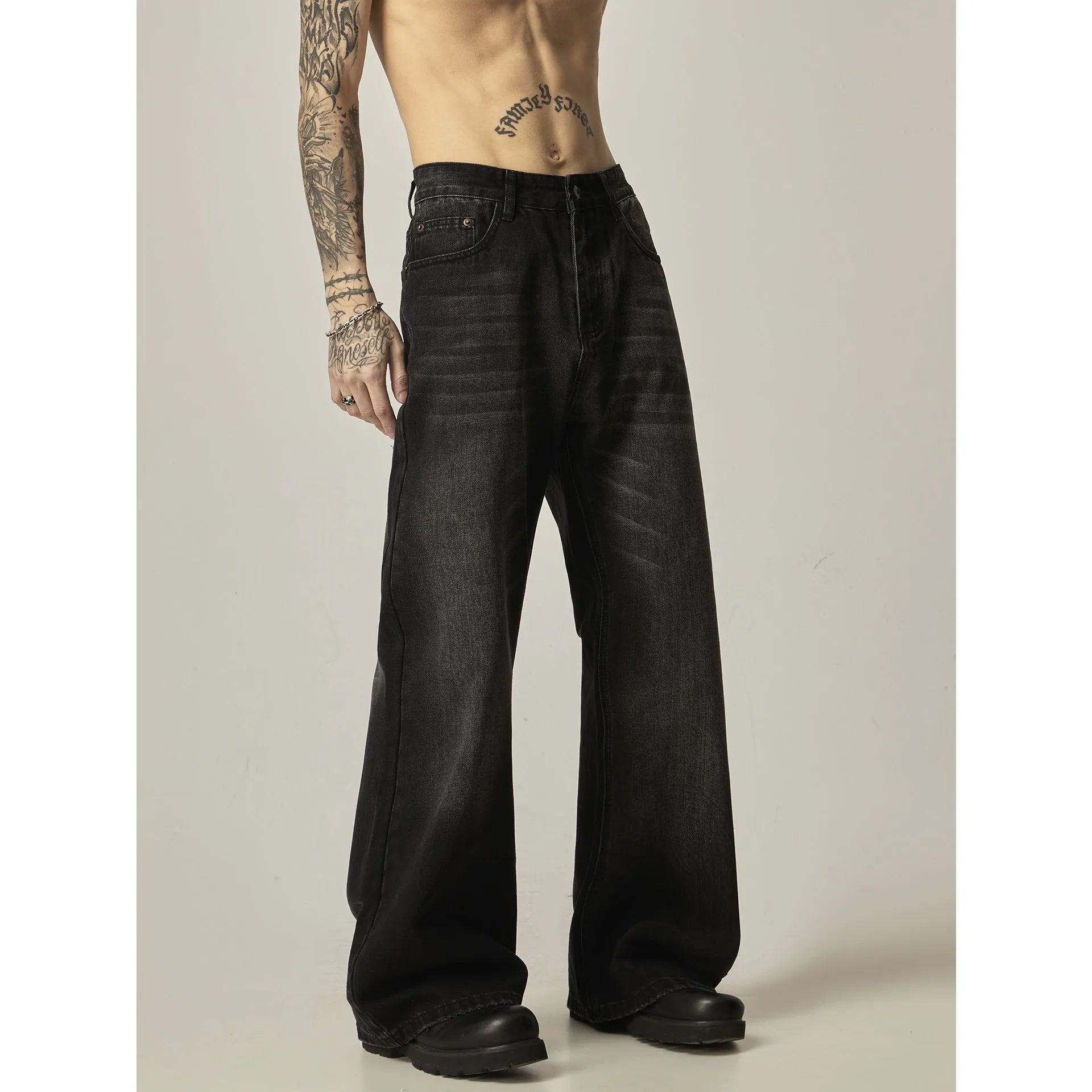 Black loose-fit straight-leg retro jeans with a zipper fly on a mannequin.