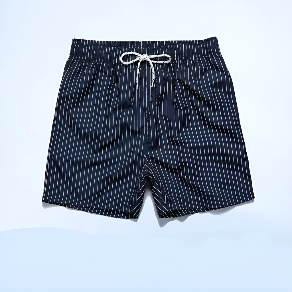 Man or woman wearing striped polyester shorts in navy blue, straight leg style, for beachwear.