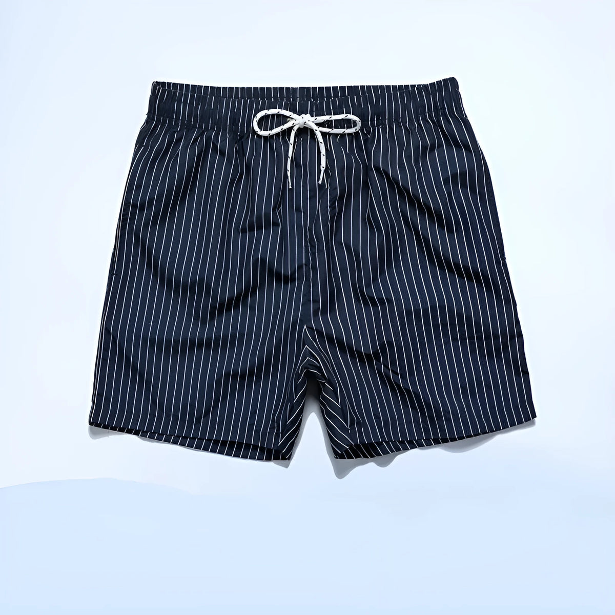 Man or woman wearing striped polyester shorts in navy blue, straight leg style, for beachwear.