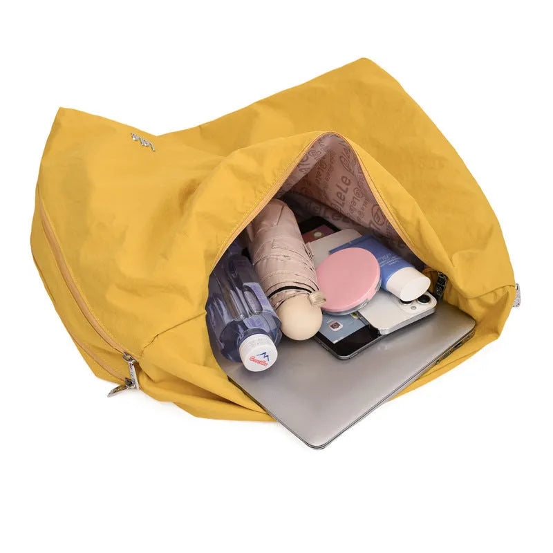 Heart-shaped nylon underarm bag for women in black, blue, khaki, and yellow colour options.