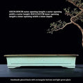 Green handmade ceramic bonsai pot with purple sand crackled glaze on wooden surface