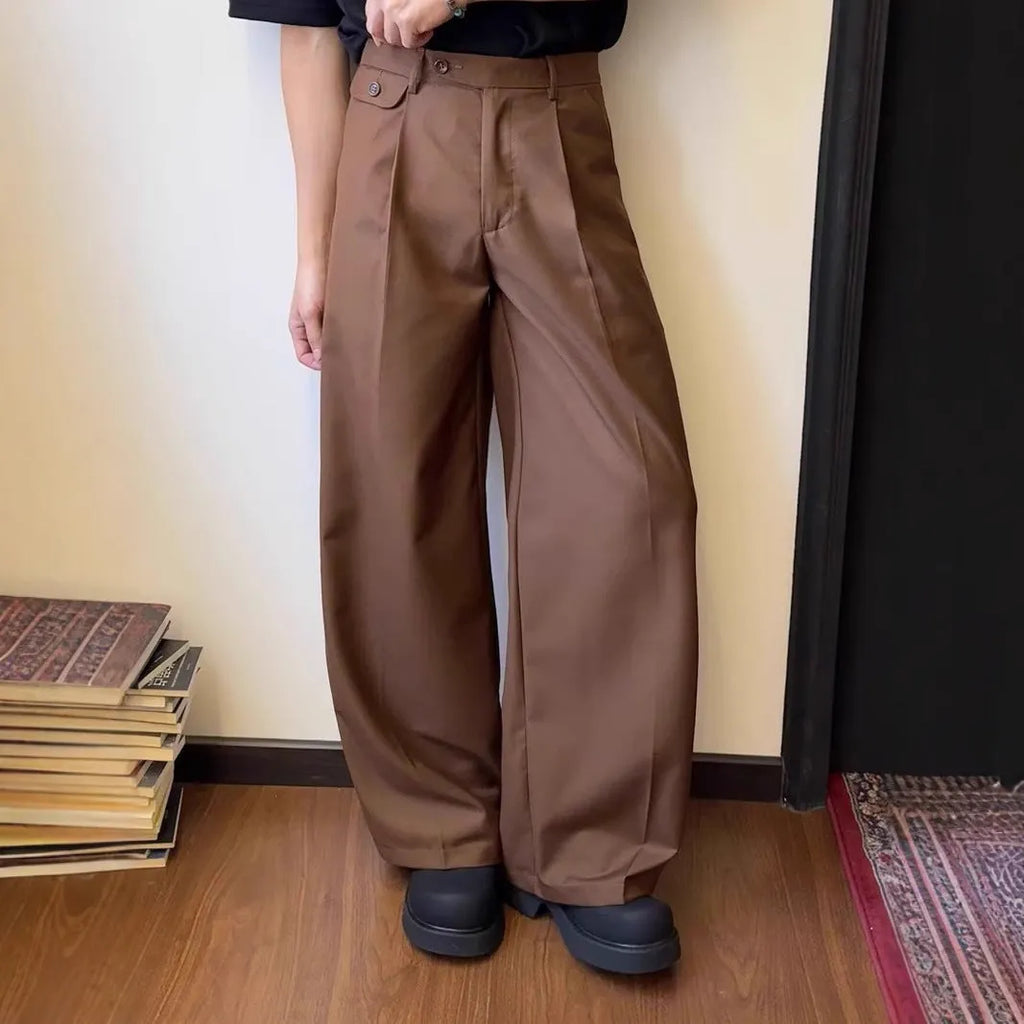 Men's loose-fitting straight-leg trousers in brown and black colours on a hanger