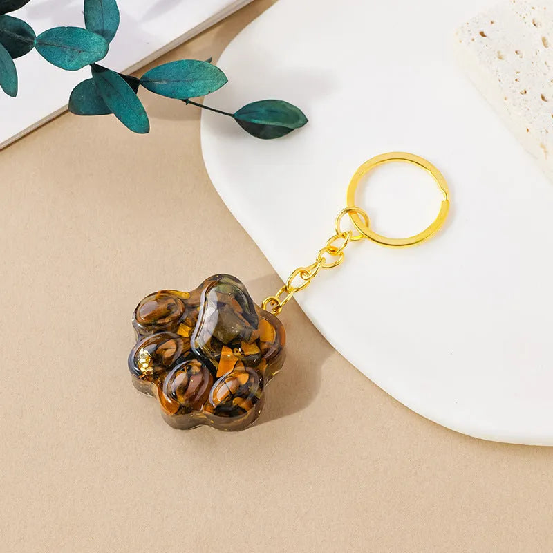 Small handcrafted crystal cat's paw shaped keychain pendant on a keyring.