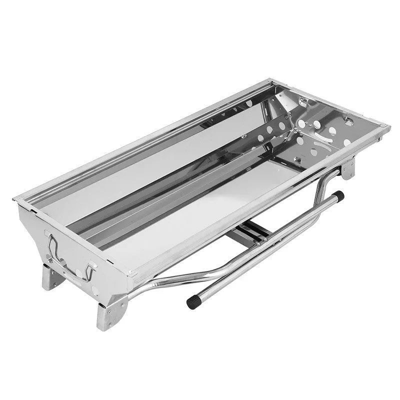 Large stainless steel portable folding barbecue oven set up outdoors.
