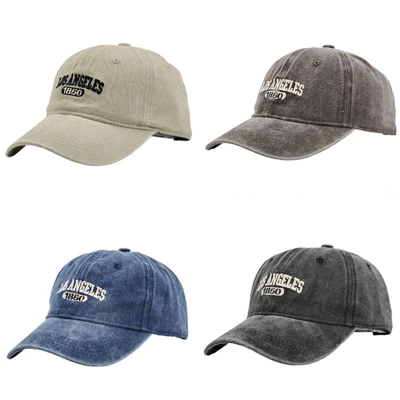 Retro style peaked cap with embroidered distressed letters on the front, shown in beige colour.