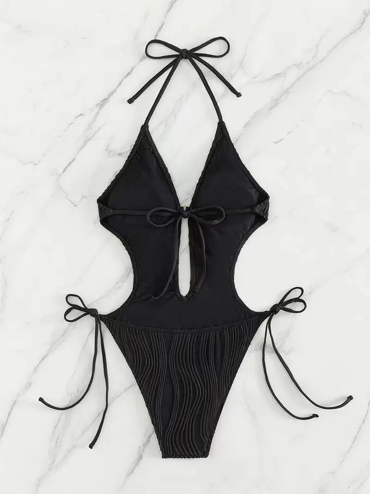 Women's black triangle bikini with adjustable front lace-up detail, shown on a mannequin.