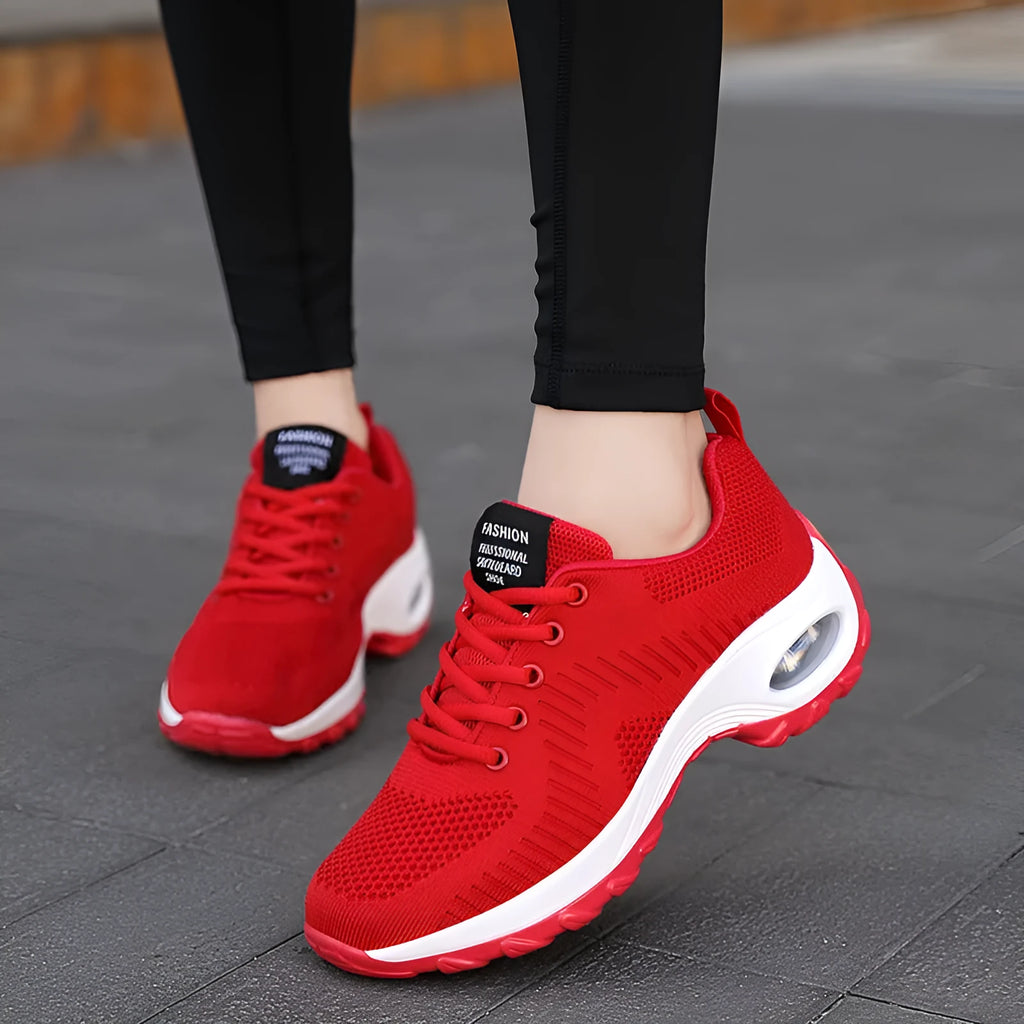 Women's red mesh sneakers with round toe and front lace-up design on flat heel