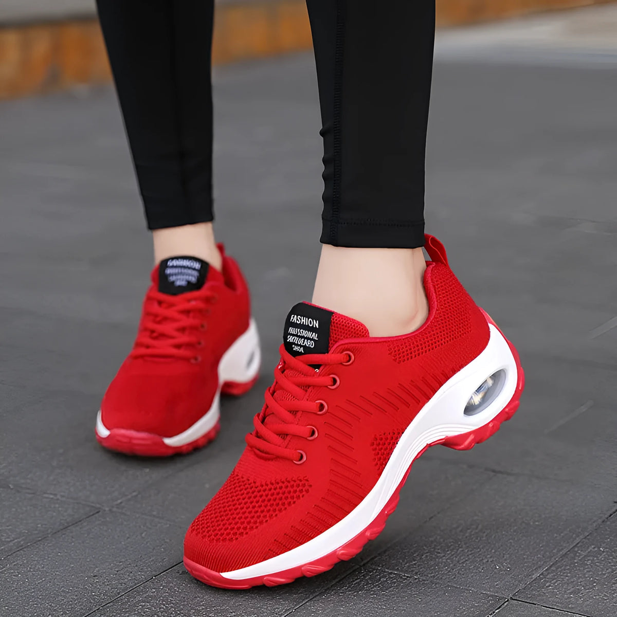 Women's red mesh sneakers with round toe and front lace-up design on flat heel