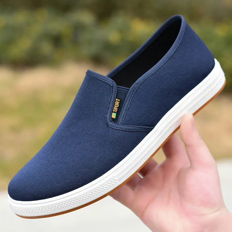 Men's low-top canvas slip-on shoes in blue colour showing round toe and shallow mouth design