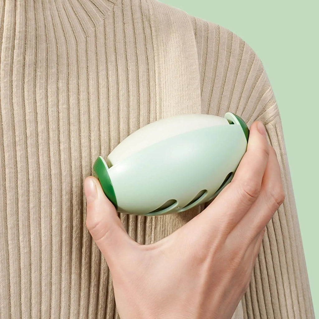 Green reusable gel lint roller ball for pet hair removal on fabric