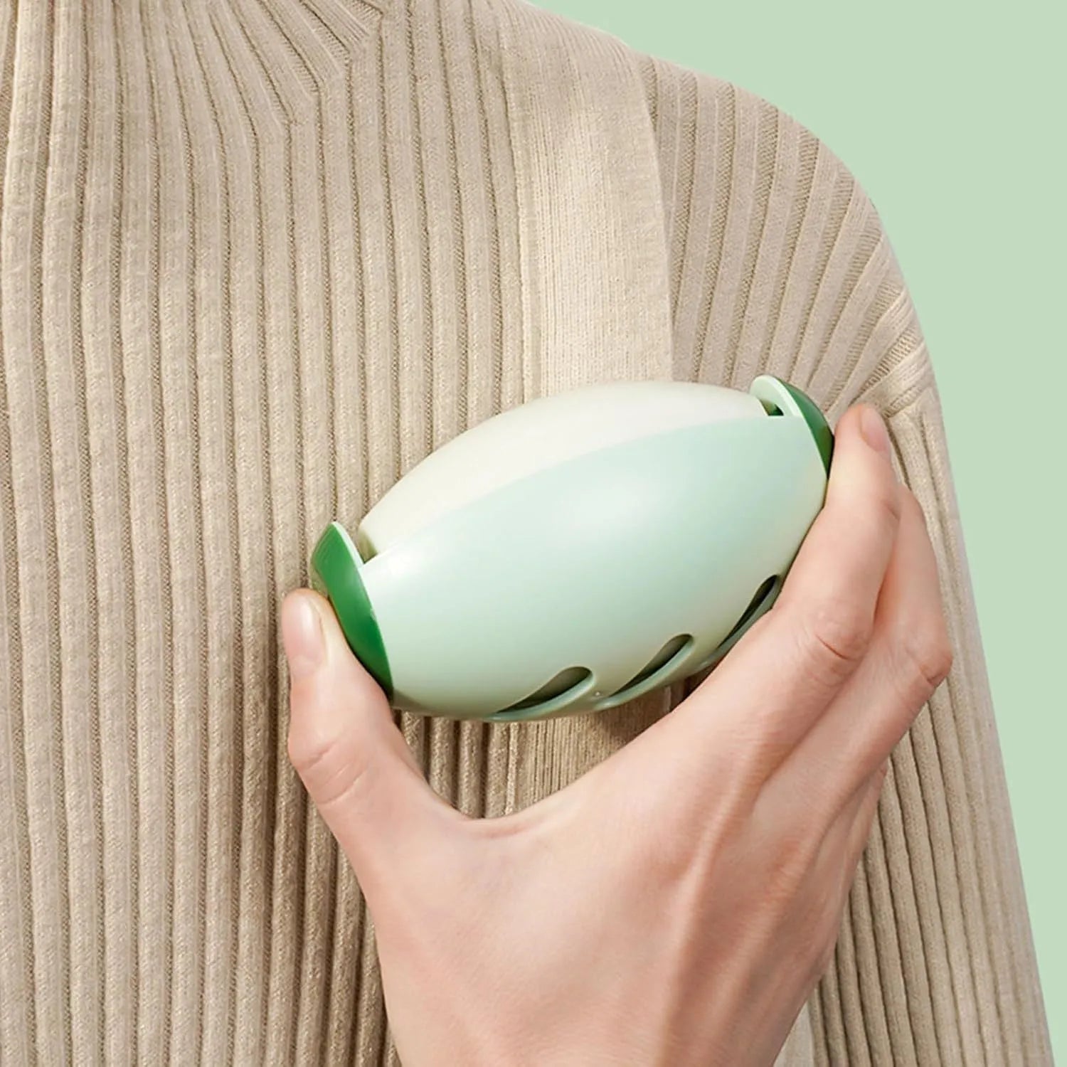 Green reusable gel lint roller ball for pet hair removal on fabric