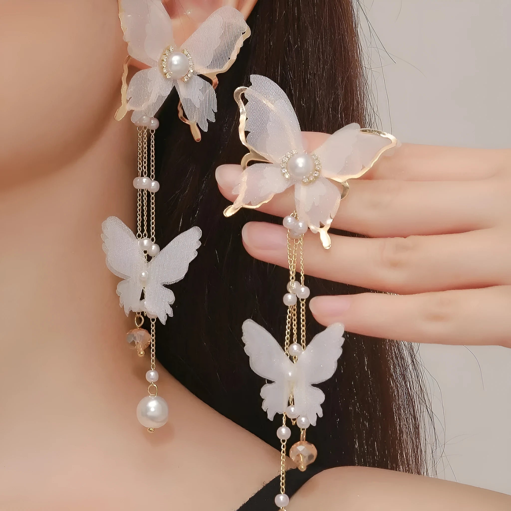 White electroplated butterfly tassel lace pearl rhinestone earrings with insect-shaped design