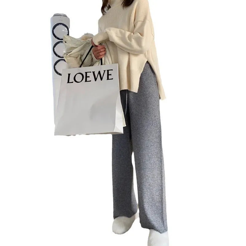 Women's knitted wide-leg trousers in black with high waist and mopping hem detail