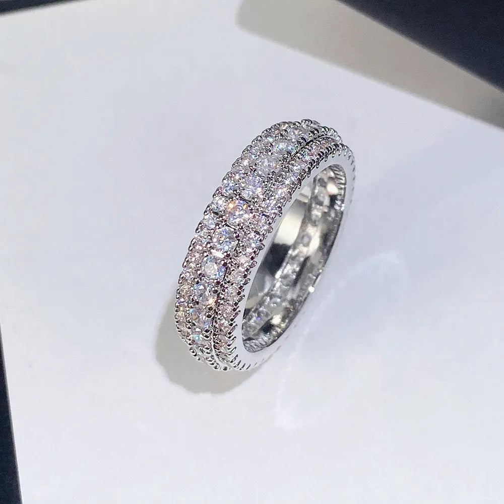 Geometric triangular copper engagement ring with zircon stone inlay, shown in white gold plating.