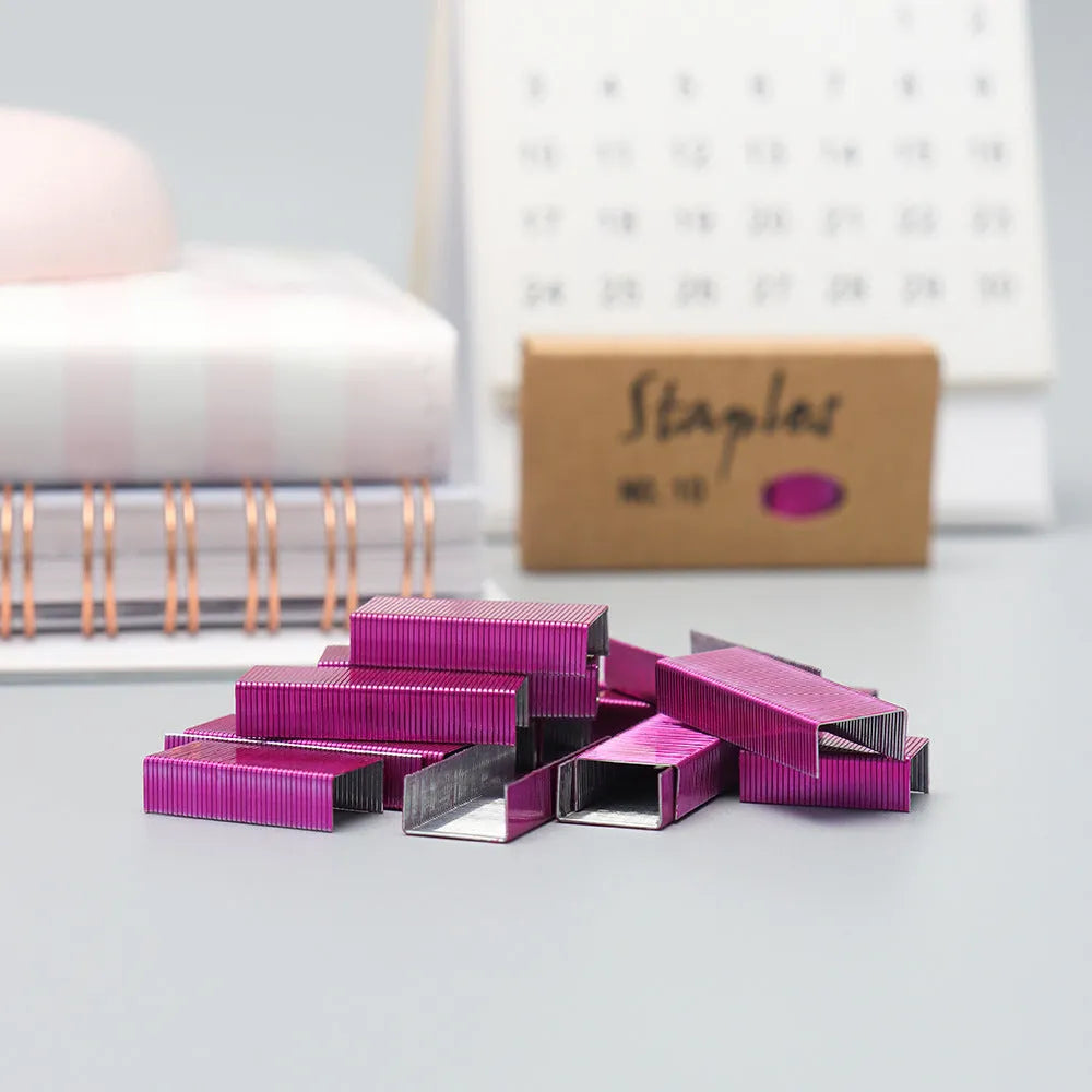 Box of 1000 metal office staples showing colour options: black, purple, rose gold, rose red
