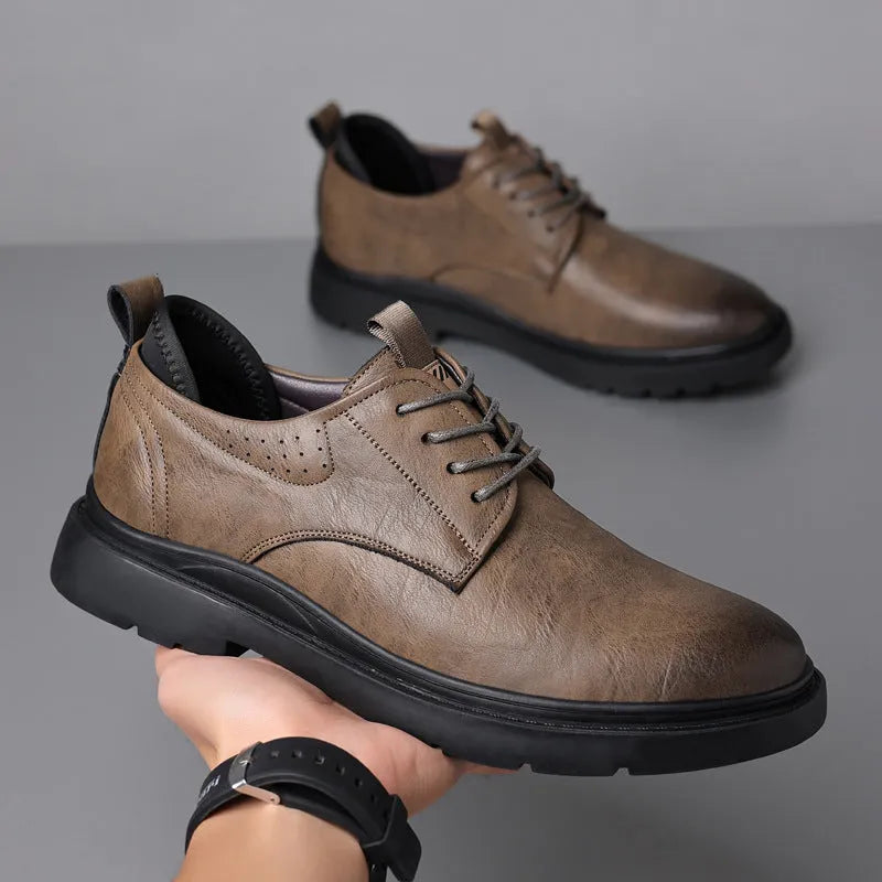Men's black leather casual sneakers with sewing line detailing and rubber soles