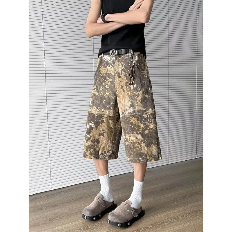 Women's yellow snake pattern camouflage print cropped denim jeans laid flat.