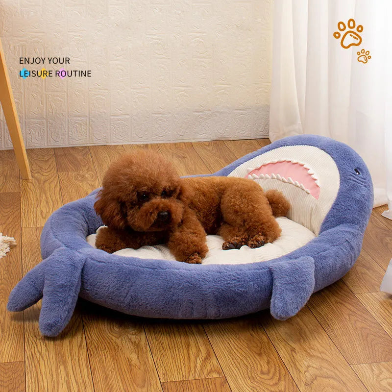 Blue shark pattern pet bed cushion for dogs or cats on a wooden floor.