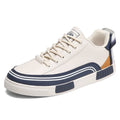 Men's white and green canvas casual shoes with visible mesh panel sections on a flat heel.