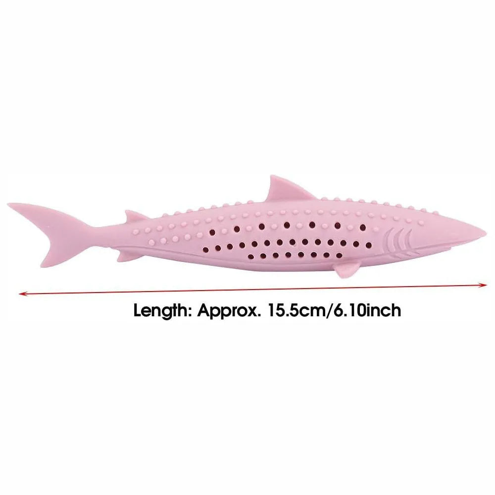 Green silicone fish-shaped cat chew toy with dolphin details and visible side holes.