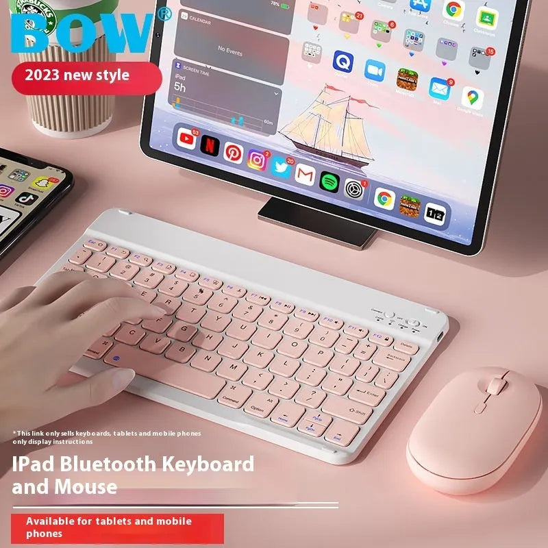 Compact white Bluetooth keyboard for tablet and PC use on a wooden desk