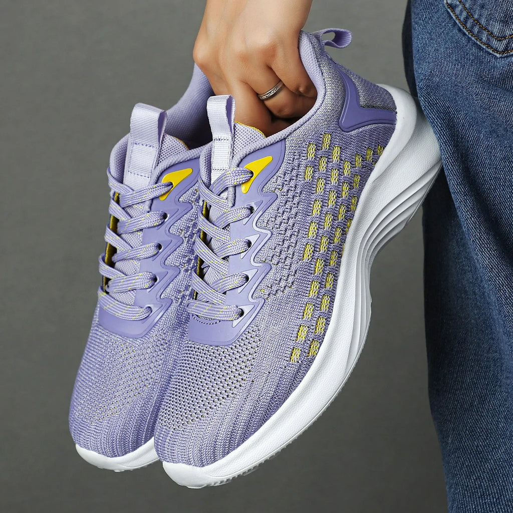 Women's lavender purple Flyknit running shoes with mesh lining and EVA sole, shown in a side view.