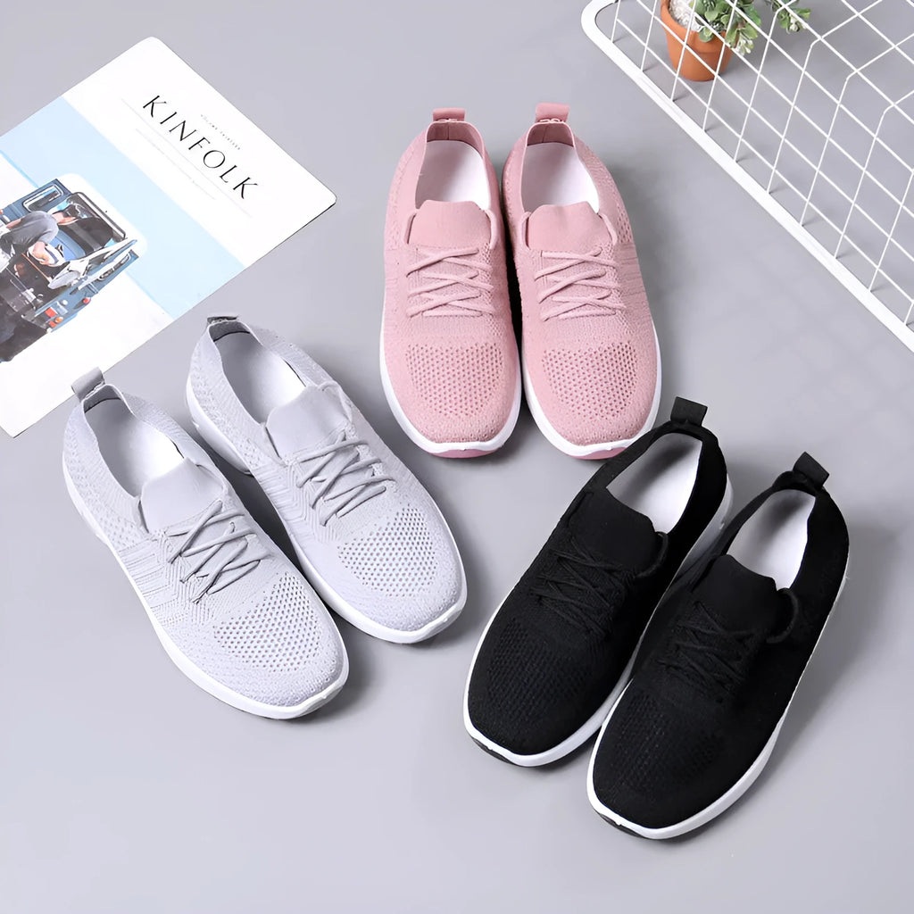 Women's black casual sneaker with mesh upper, lace-up front, and soft PVC sole.