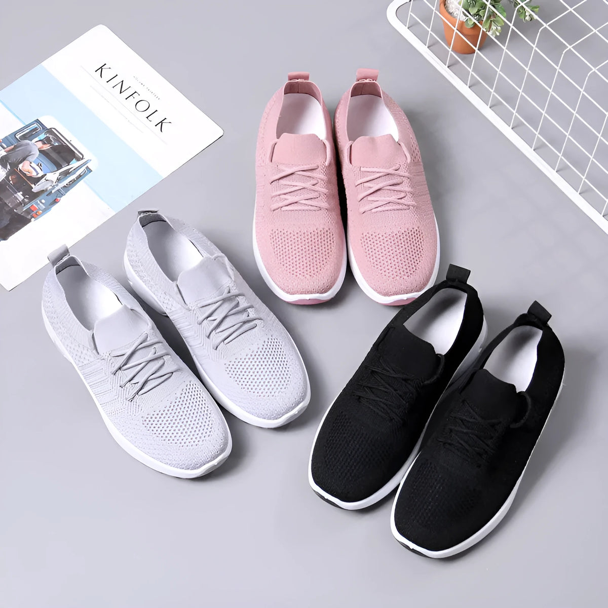 Women's black casual sneaker with mesh upper, lace-up front, and soft PVC sole.