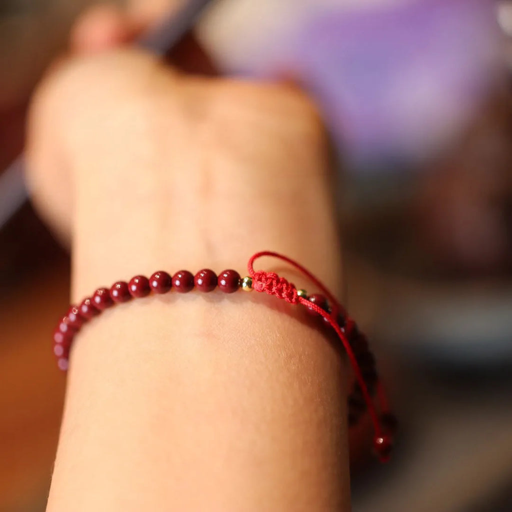 Handcrafted natural cinnabar bracelet with purple gold sand geometric design and auspicious Chinese patterns