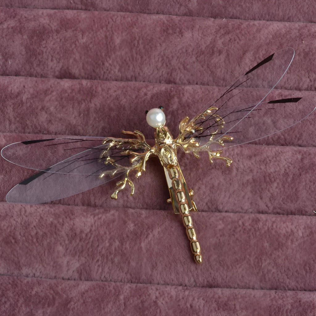 Gold-coloured dragonfly headdress with side clip fastening and floral decorative elements