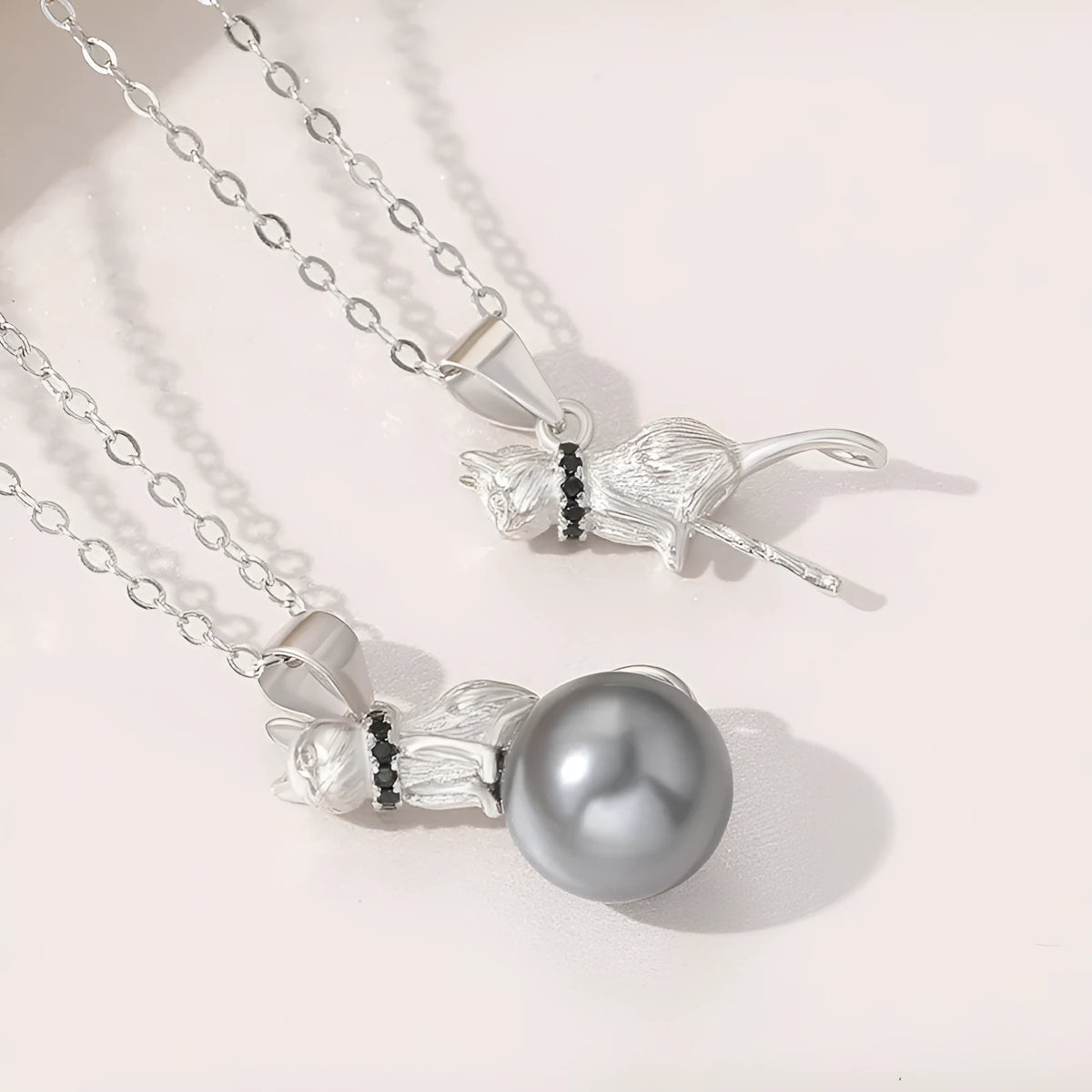 Sterling silver cat pendant necklace with adjustable chain, showing delicate feline silhouette charm
