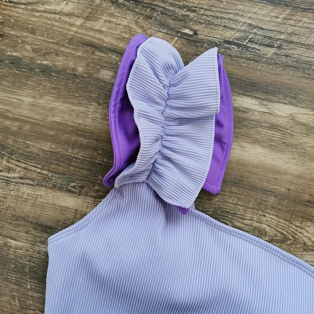 Women's single-shoulder high-waist one-piece swimsuit in a solid colour.
