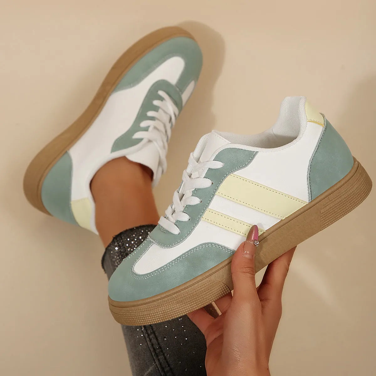 Green women's low-top casual pumps with cross-strap design and flat rubber sole.