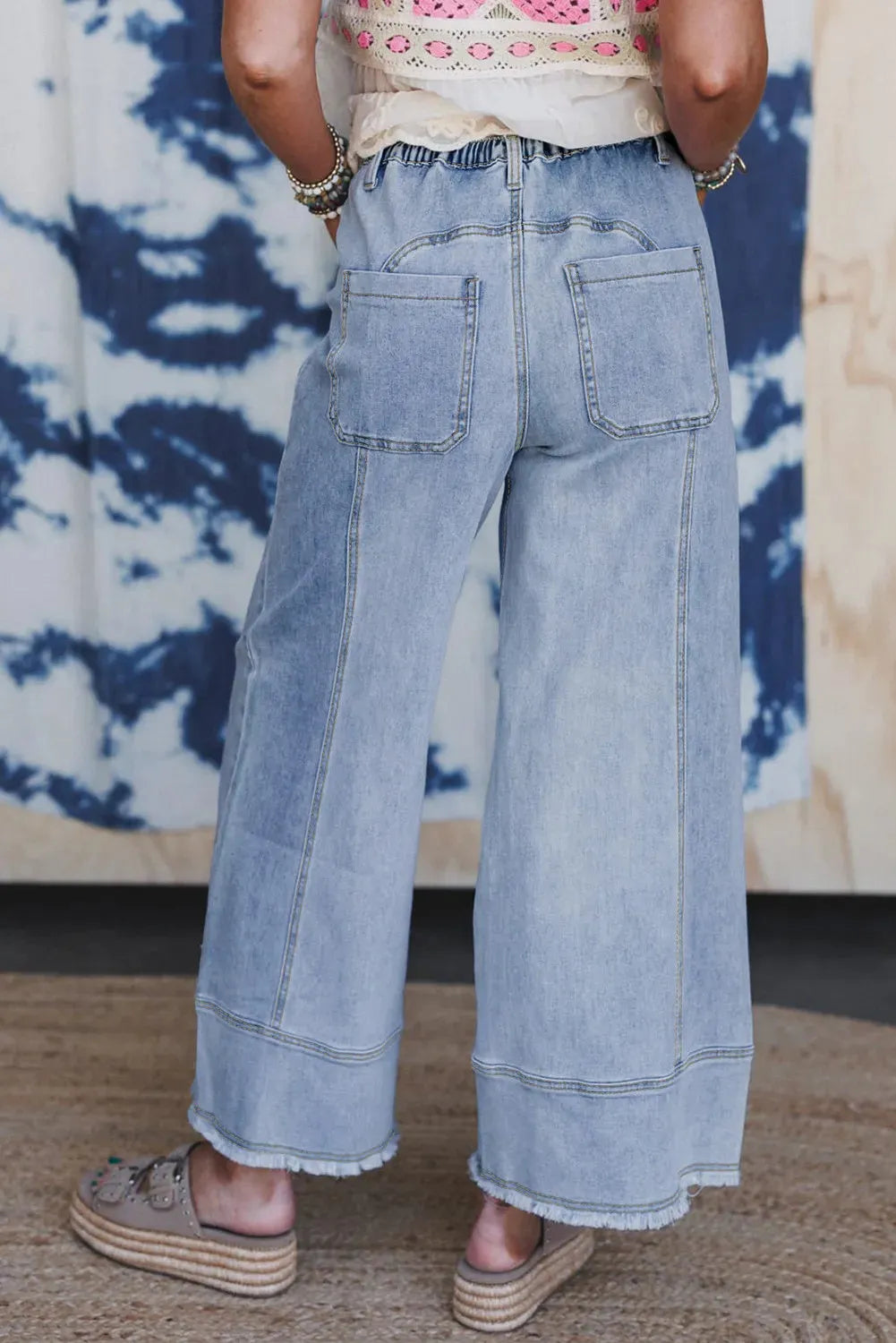 Beau blue wide leg denim trousers with drawstring waist and raw hem detail
