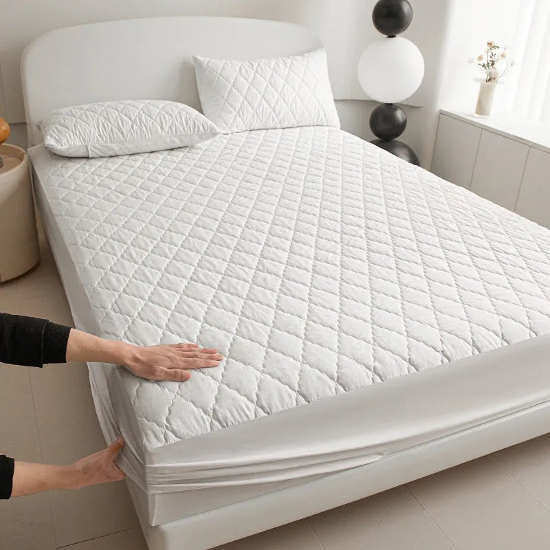 Diamond lattice quilted waterproof mattress protector set with fitted sheet and pillowcases in solid colour.