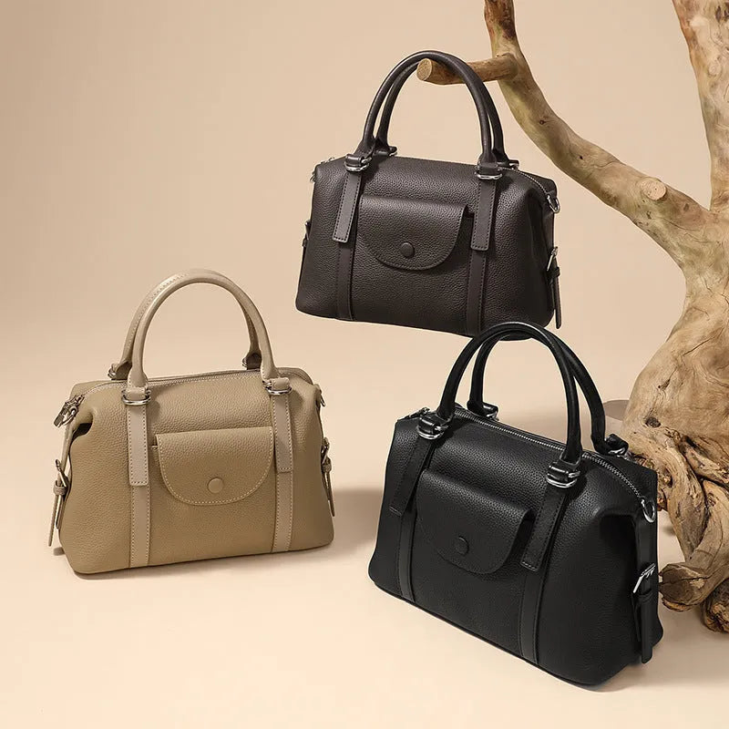 Genuine leather ladies shoulder bag in street trend style with lock detail and contrast stitching.