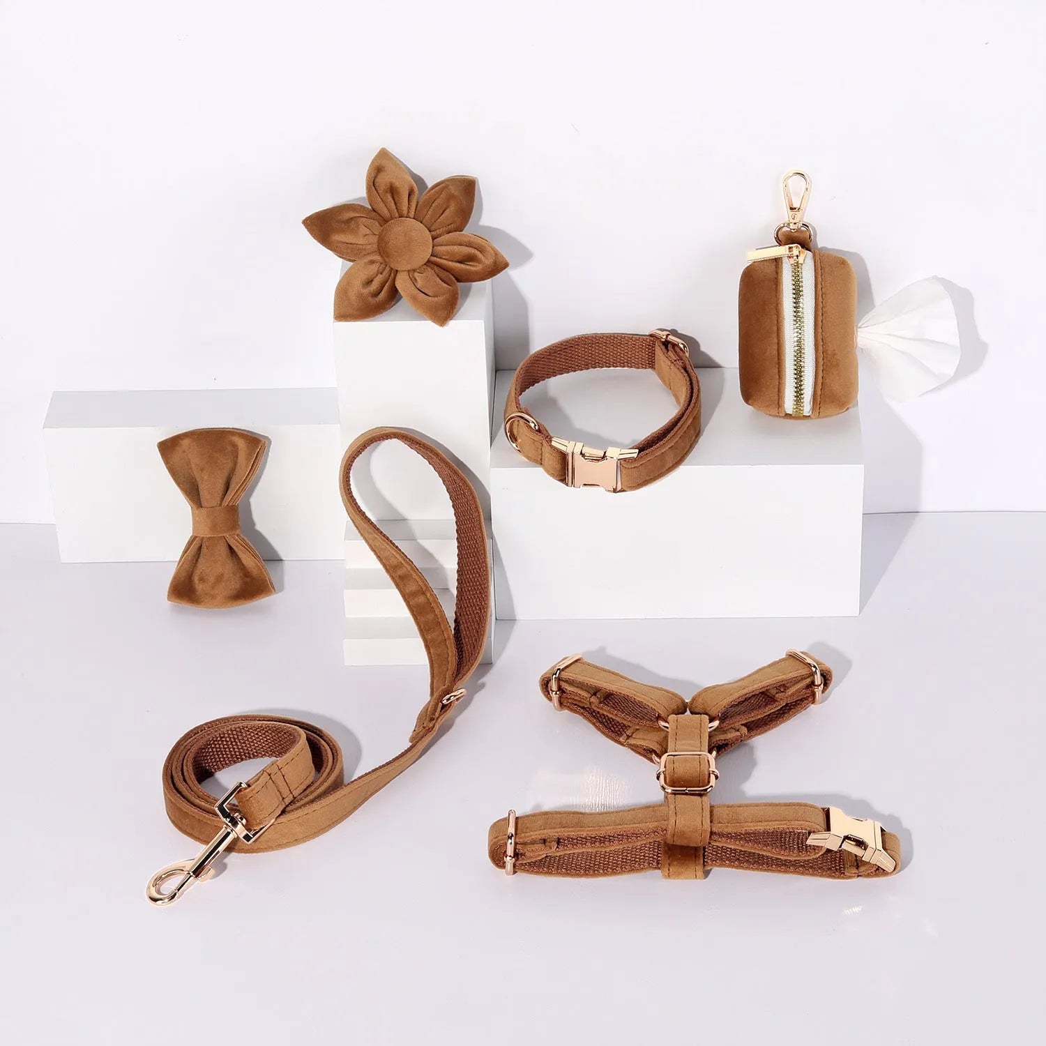 Complete velvet dog collar and traction rope set with bow tie, flower, and toilet bag on a table