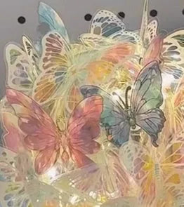 Handmade butterfly night lamp with glass shade and wood base on bedside table