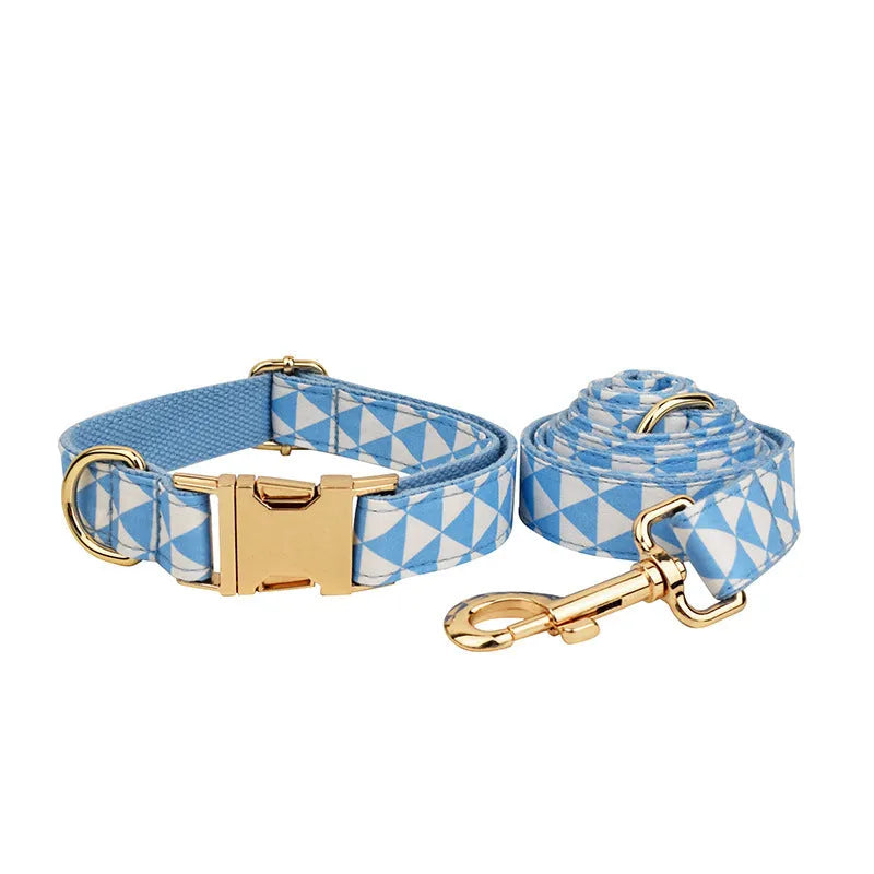 Blue cloth dog collar, leash, vest, and bow set arranged together showing all four pieces.