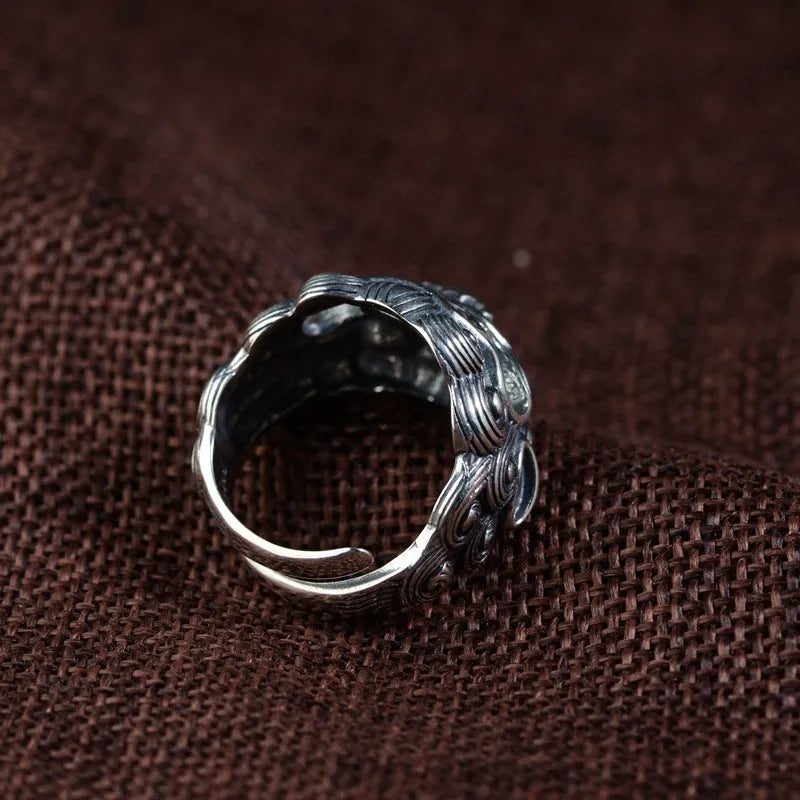 Silver open ring with domineering jibeast pattern showing animal zodiac modelling details
