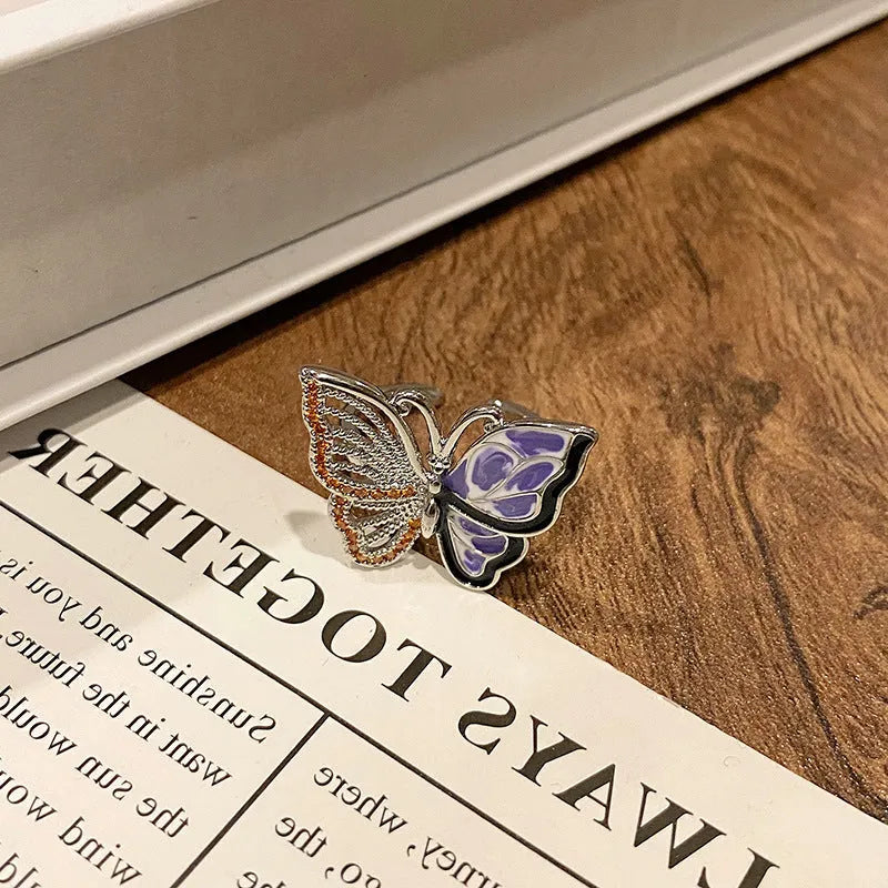 Copper butterfly women's ring with drip oil finish in an open-loop design.