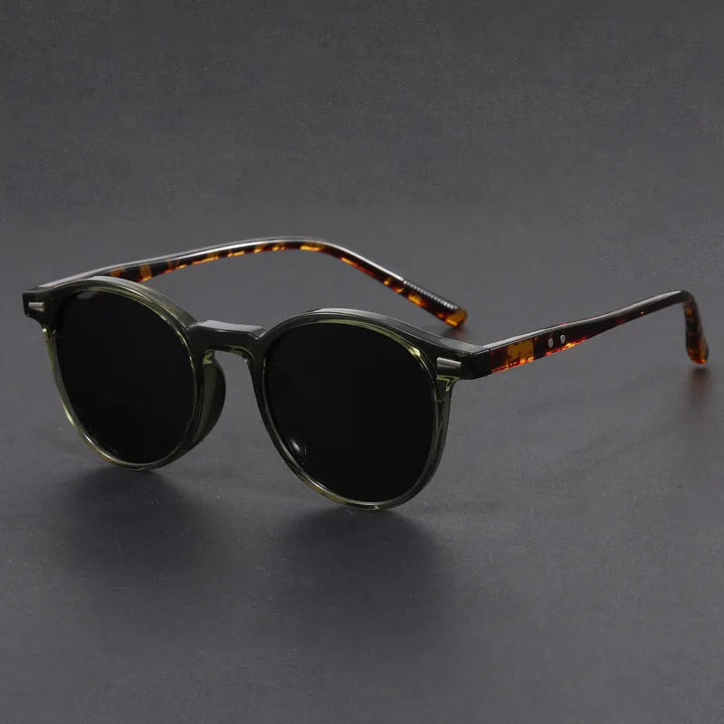 Retro oval round frame sunglasses with grey polarised lenses shown in sand black frame colour.