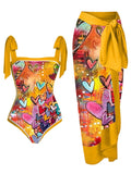 Women's floral print two-piece swimsuit with a sheer black chiffon hip skirt overlay.