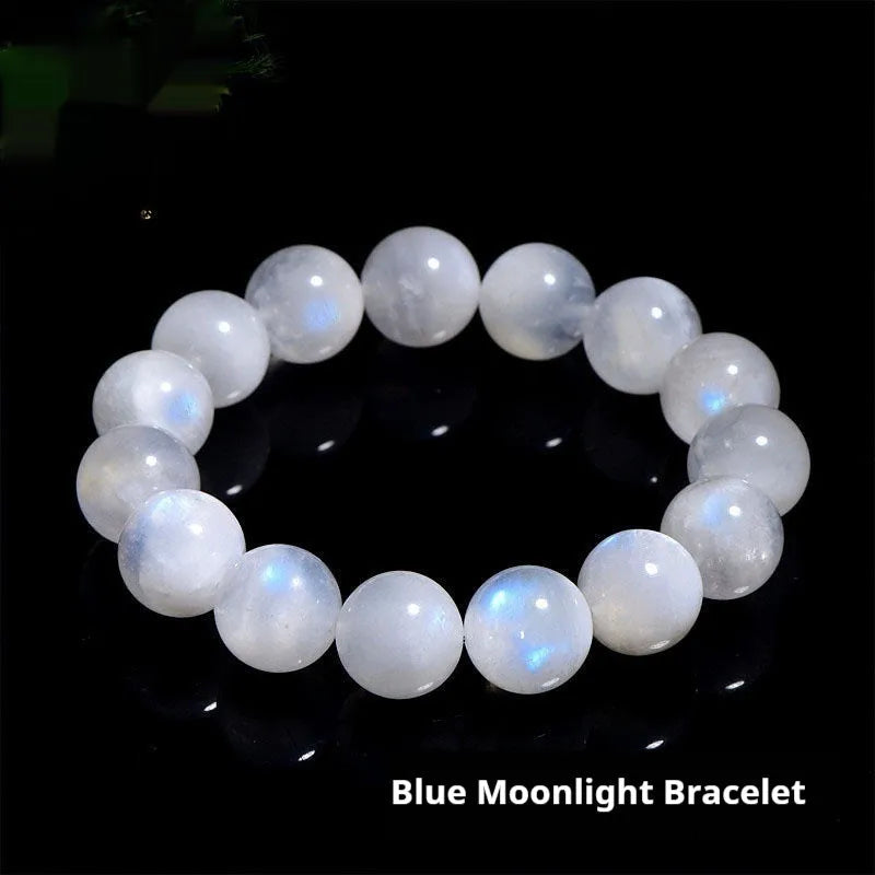 Natural blue polished moonstone round bead bracelet with adjustable clasp on a wrist.